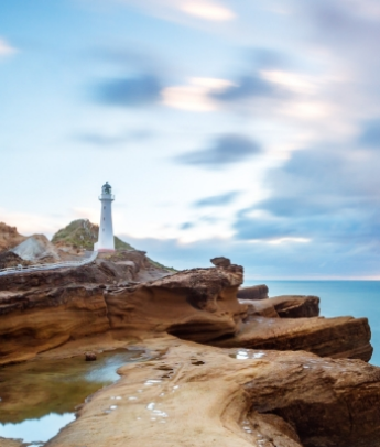 A lighthouse on a rocky beach