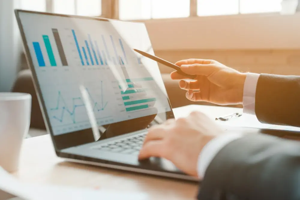 Person analyzing business charts on laptop, illustrating cash-flow planning